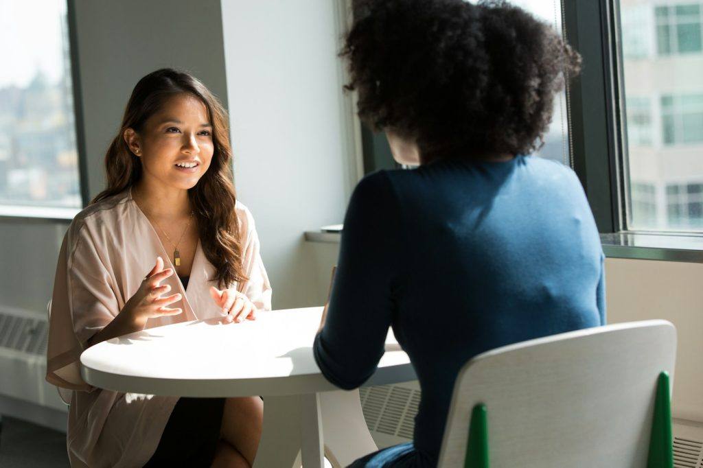 Two women seated facing each other during a job interview