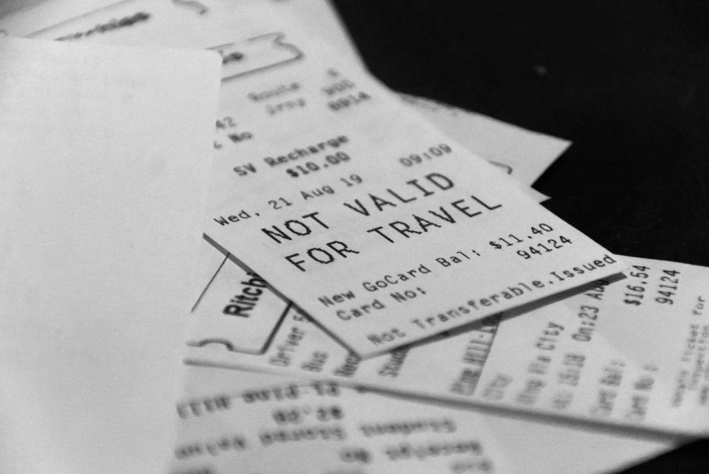 Pile of crumpled paper receipts spread across a table
