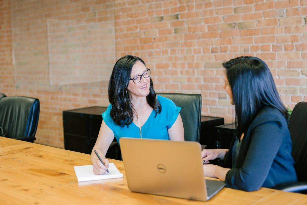 Manager and employee talking during a one-on-one review meeting