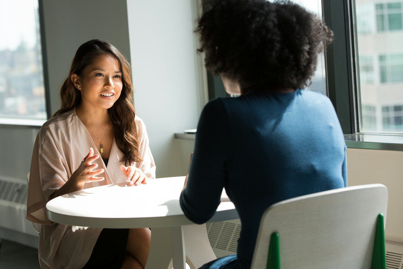 Recruiter interviewing a candidate at a small table